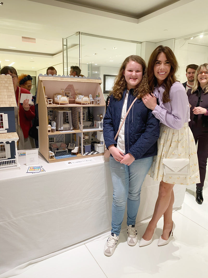 Ella with designer Caitlin Wilson beside a miniature room display at a House Beautiful event in New York City